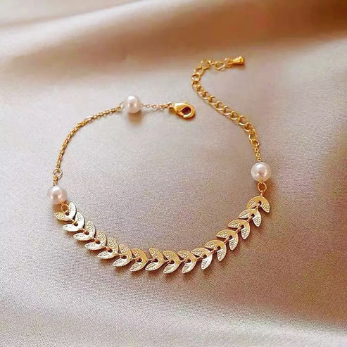 "Stainless steel bracelet embellished with elegant wheat ear and pearl motifs."